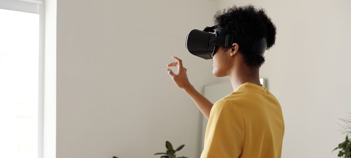 A young man in his living room with a VR headset on