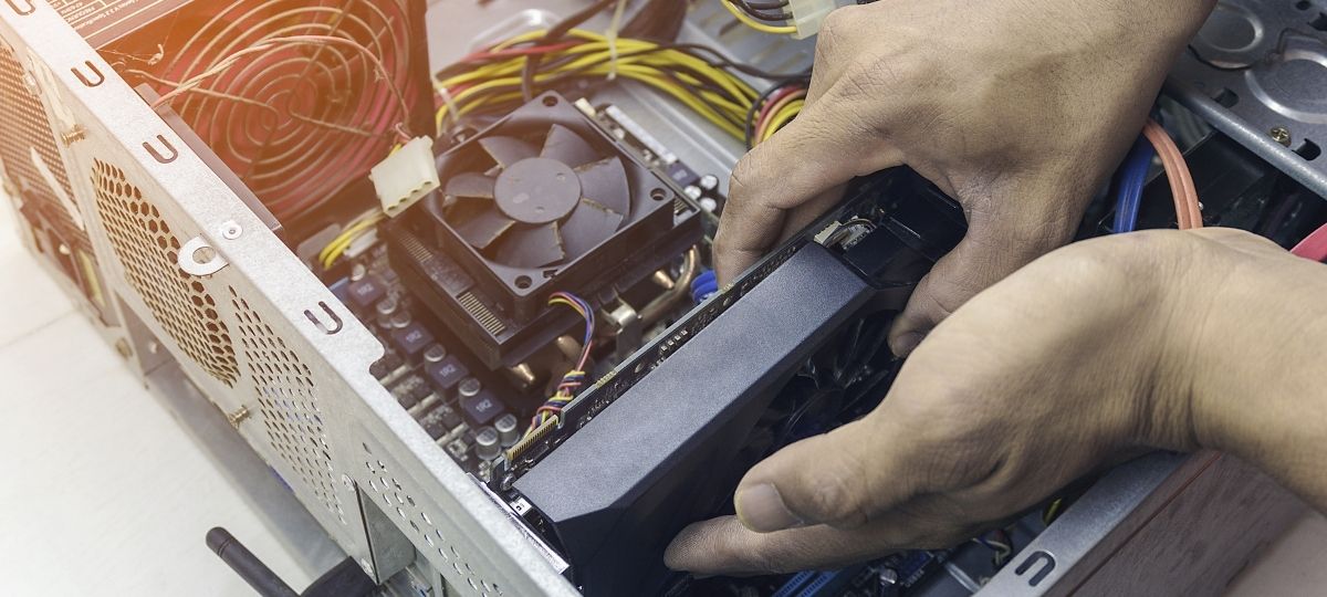 Someone installing a computer part into a computer tower