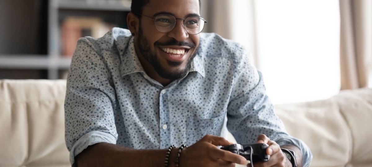 A man sitting in his living room enjoying video games