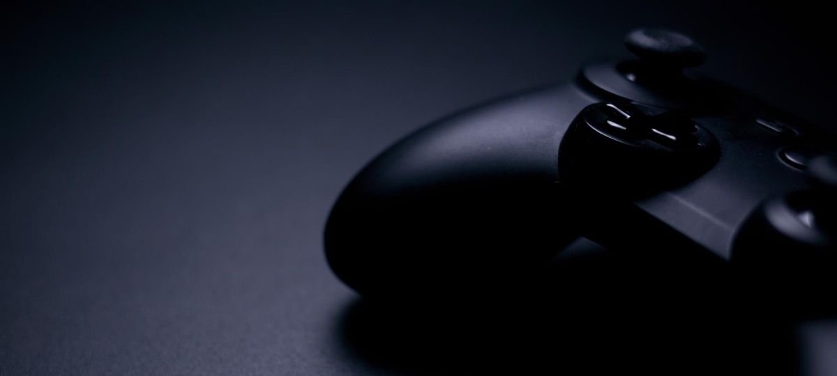 ps4 controller sitting on a desk in a dark setting