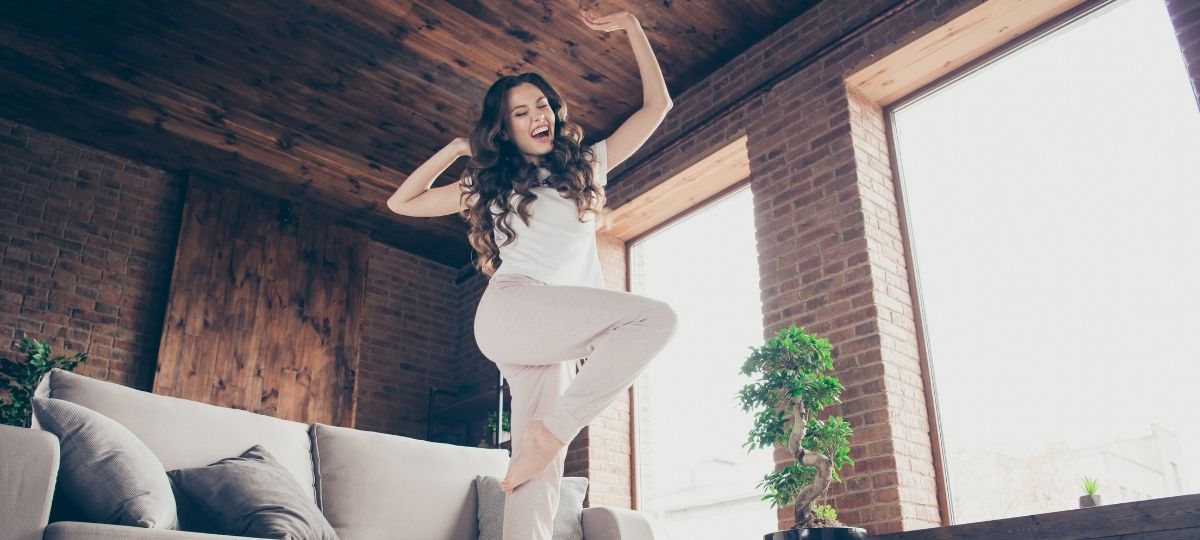 A young woman celebrating in her living room