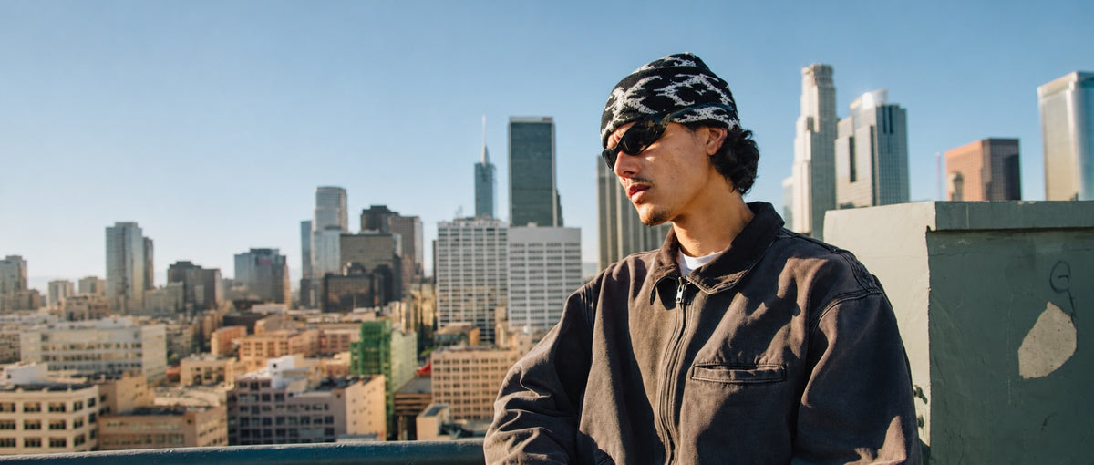 Trevor Colden wearing his signature black eyewear on a Los Angeles rooftop