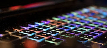 closeup photo of a led lit keyboard in a dark room