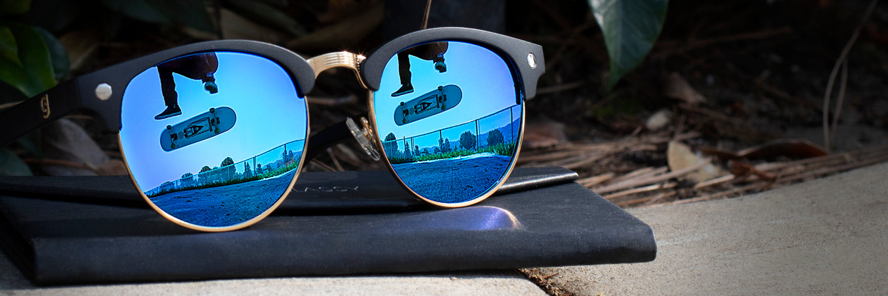 Sunglasses with a skateboarder in its reflection