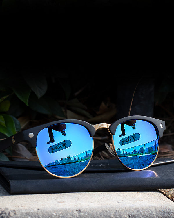 Sunglasses with a skateboarder in its reflection